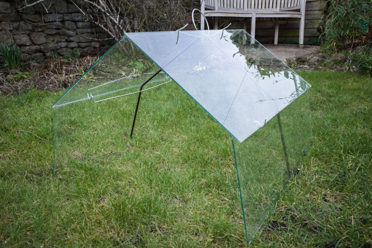 An assembled Low Barn glass cloche on a lawn