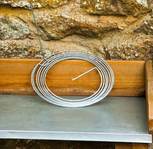 Unpacked Spiraclimb metal plant support on a potting bench